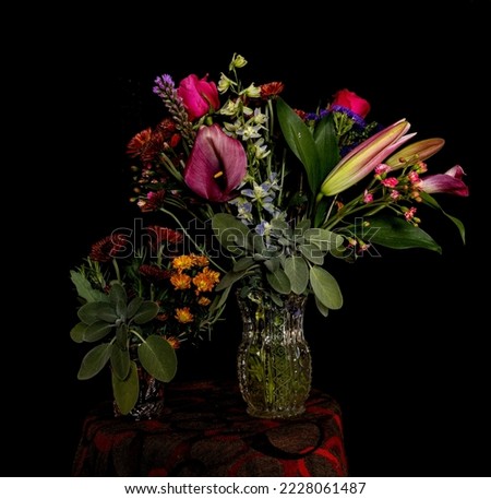 Bouquet of flowers in a glass jar with black background