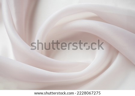 Texture chiffon fabric in pink color for backgrounds. silk fabric. selective focus Royalty-Free Stock Photo #2228067275