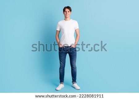 Full body picture of casual man with hand in pocket on blue color background.