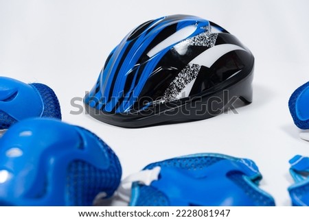 Children's set of protection for cycling, skateboard, roller skates - helmet, knee pads, elbow pads, gloves. Royalty-Free Stock Photo #2228081947