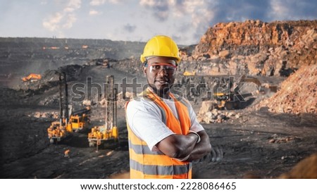 African american worker geology background big drilling yellow mining truck for coal. Concept open pit mine industry. Royalty-Free Stock Photo #2228086465