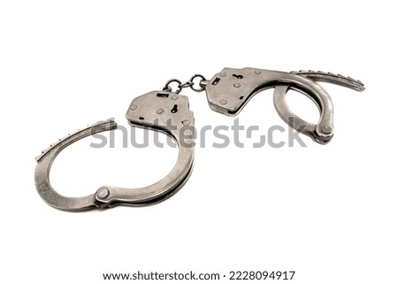 Handcuffs on a white background close-up. Handcuffs isolated. Law. Crime