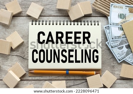 CAREER COUNSELING, written on white sticky note money and wooden blocks top view