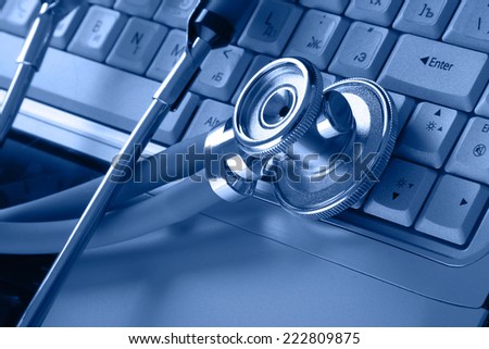 Stethoscope resting on a computer keyboard.