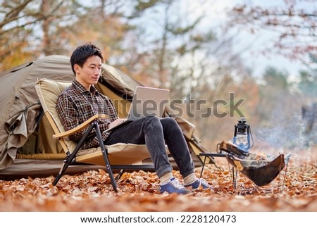 Young Japanese man enjoying solo camping