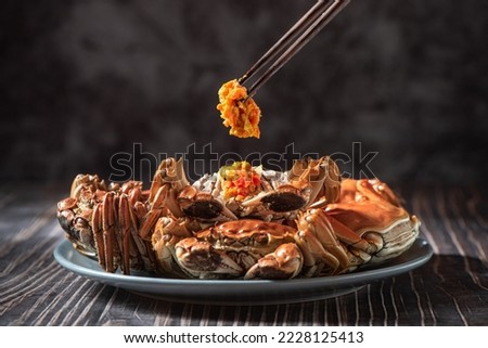 Fresh and delicious hairy crab or chinese mitten crab with crab roe on table Royalty-Free Stock Photo #2228125413