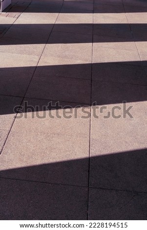 Tiled street surface with column shadows. Background image.