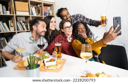Large group of friends taking selfie picture smiling at camera - Young people having fun and drinking beer 