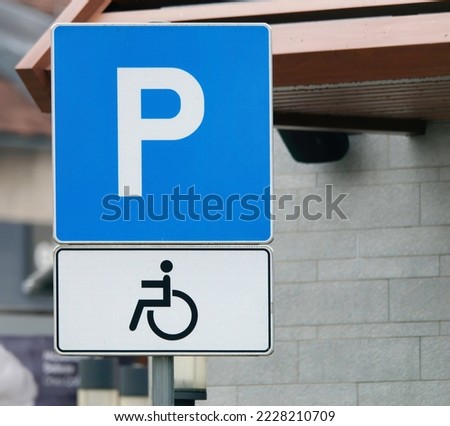 Close-up photo of a handicapped parking sign attached to a pole