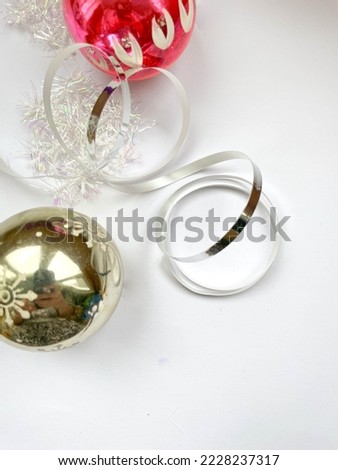 Christmas decorations on a white background with shiny snowflakes and a silver ribbon.