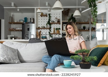 Young business woman home interior designer working on her laptop for new client who bought apartment. Female Feng Shui expert looking on her computer design of furniture. Royalty-Free Stock Photo #2228245927