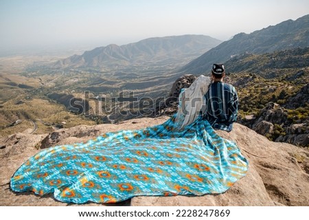 The Uzbek young couple on the mountain pass in Samarkand.