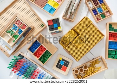 Montessori materials for secondary school learning math. Educational logical geometric wooden ecology details for counting at mathematical lesson arrangement at box for storage on table top view Royalty-Free Stock Photo #2228252001