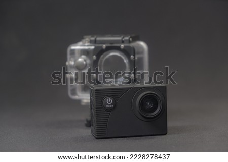 Action Cam on a Black textured Background with a Waterproof case