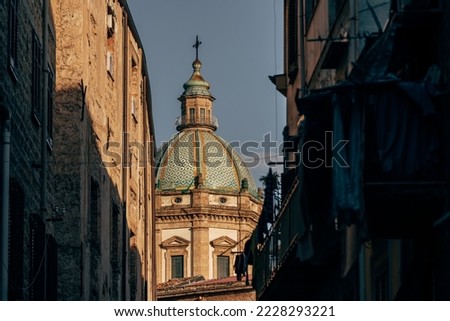 Chiesa del Gesù cupola on sunset seen between old buildings in Palermo, Sicily, Italy Royalty-Free Stock Photo #2228293221
