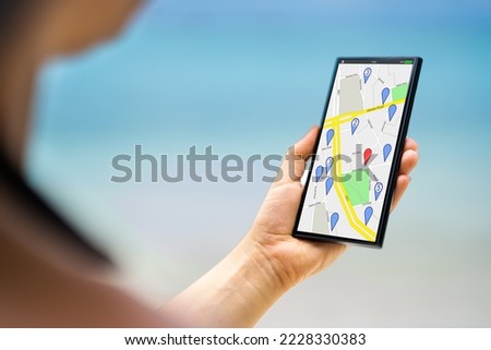 Phone Mobile GPS Navigator Map. GPS Cellphone On Beach