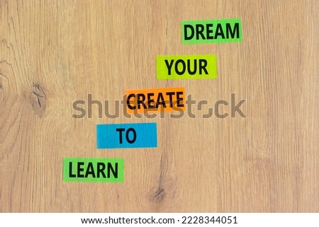 Create your dream symbol. Concept words Learn to create your dream on colored paper. Beautiful wooden table wooden background. Business learn to create your dream concept. Copy space.