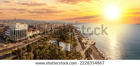 Sunset in Cyprus. Limassol beach. Embankment with piers. Cyprus on summer evening. Panorama Limassol resort. Urban landscape with hotels near sea. Cyprus tourism. Panorama Limassol view from drone Royalty-Free Stock Photo #2228354867