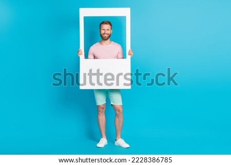 Full length photo of nice young man hold social media post photo frame model wear trendy pink outfit isolated on cyan color background
