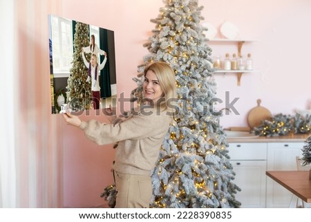 woman holding a photo canvas as a Christmas present