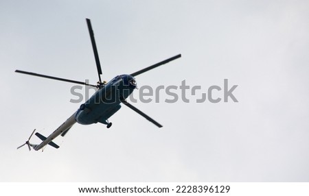 Passenger tourist helicopter Mi-8 doing sightseeing flight. Helicopter in the sky bottom view. Royalty-Free Stock Photo #2228396129