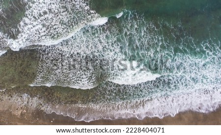Aerial View Of Ocean Waves Crashing On Beach