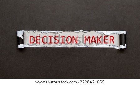 Closeup on businessman holding a card with DECISION MAKER message