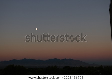 Moon setting over the Oquirrh Mountains in Salt Lake City, Utah