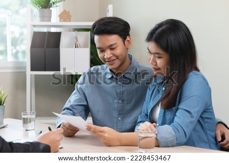 Asian couple meeting real estate agent consulting to mortgage house