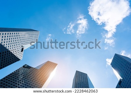 Office tall building. Low angle view of skyscrapers modern office building city in business center with blue sky Royalty-Free Stock Photo #2228462063