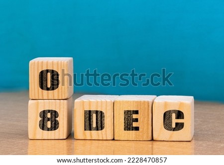 Cube shape calendar for December 08 on wooden surface with empty space for text,cube calendar for december on wood background. Royalty-Free Stock Photo #2228470857