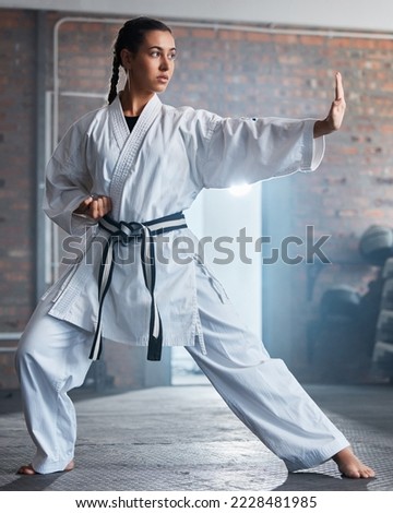 Karate training, fitness and woman in gym, healthcare motivation and strong focus for fight workout. Fist, sport exercise and healthy athlete person or martial arts wellness for taekwondo competition Royalty-Free Stock Photo #2228481985