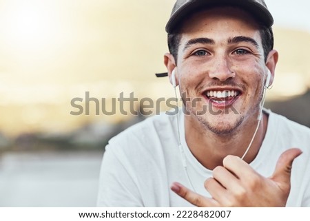 Music, portrait and man with good time hand sign relax with radio, song and online audio track in city. Podcast, face and guy with shaka hands happy with wellness playlist in New York while streaming