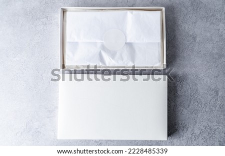 Two white square gift boxes mockup on gray concrete background. From above, top view, minimalist concept Royalty-Free Stock Photo #2228485339