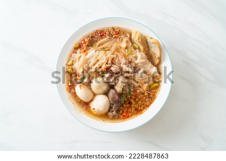 noodles with pork and meatballs in spicy soup or Tom yum noodles in Asian style Royalty-Free Stock Photo #2228487863