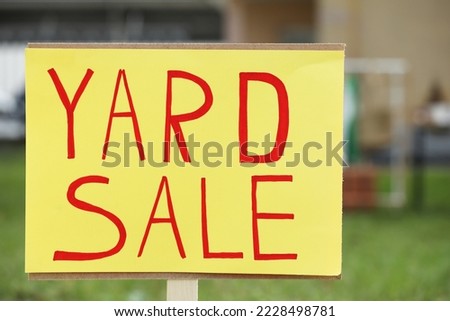 Sign Yard sale written on yellow paper outdoors, closeup