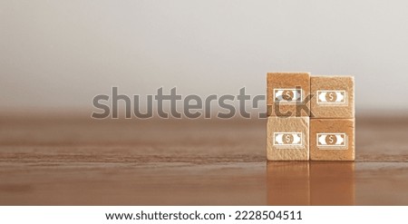 Woods block square with payment with dollar banknote (USD). Businessman shopping online shopping and paying. Futuristic Digital money transfer, e-commerce banking concept.