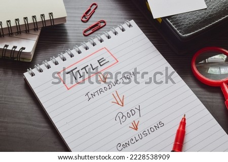 Report writing format and outline concept on notepad. Selective focus.  Royalty-Free Stock Photo #2228538909