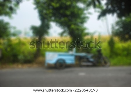 Defocus abstract background of motorcycle-drawn cart on the side of the road