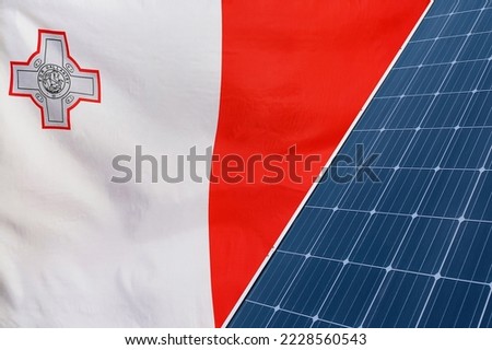 Solar panels against flag of Malta background. Solar battery generates a pure electricity. Concept of sustainable resources and renewable energy in Republic of Malta