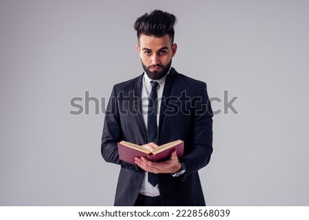 young handsome black hair man in stylish business suit in studio isolate white background