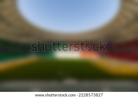 Blurrinnes unfocused ,Sport match. Back view of football, soccer fans cheering their team with colorful scarfs at crowded stadium at evening time. Concept of sport, cup, world, team, event, competition