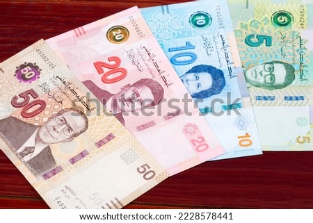 Tunisian money - dinar a business background Royalty-Free Stock Photo #2228578441