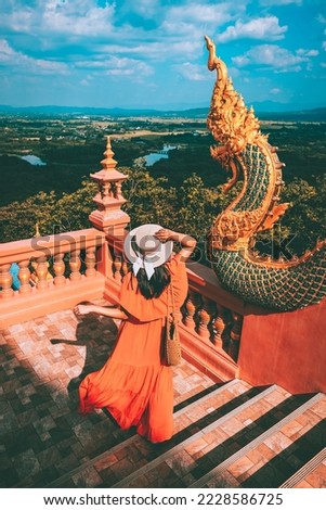 Happy traveler asian woman with dress travel in Wat Phra That Doi Phra Chan temple, Lampang, Thailand