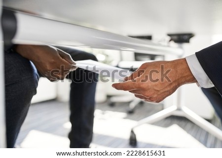 Businessman receives envelope with bribe money under table. Bribery corruption concept. Royalty-Free Stock Photo #2228615631