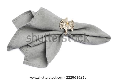 Fabric napkin with decorative ring for table setting on white background, top view Royalty-Free Stock Photo #2228616215