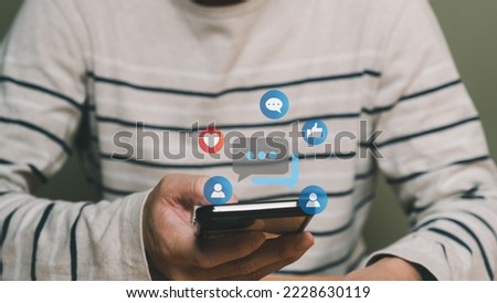 Selective focus at men hand while type on smartphone while chat and communication with friend on online social media platform. Virtual community that people can share or upload photo and content.