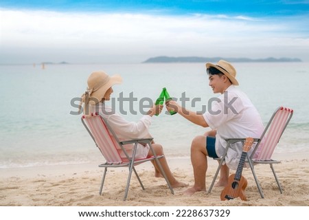 Asian traveller couple playing and sweet togather on the beach between honeymoon day at Phi phi island maya beach near Phuket, Thailand