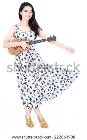 Attractive asian girl playing ukulele