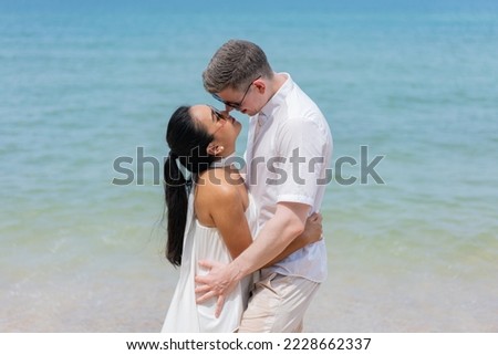 Romatic couple passionately kissing on dock. Beautifull wedding couple kissing and embracing on the beach.